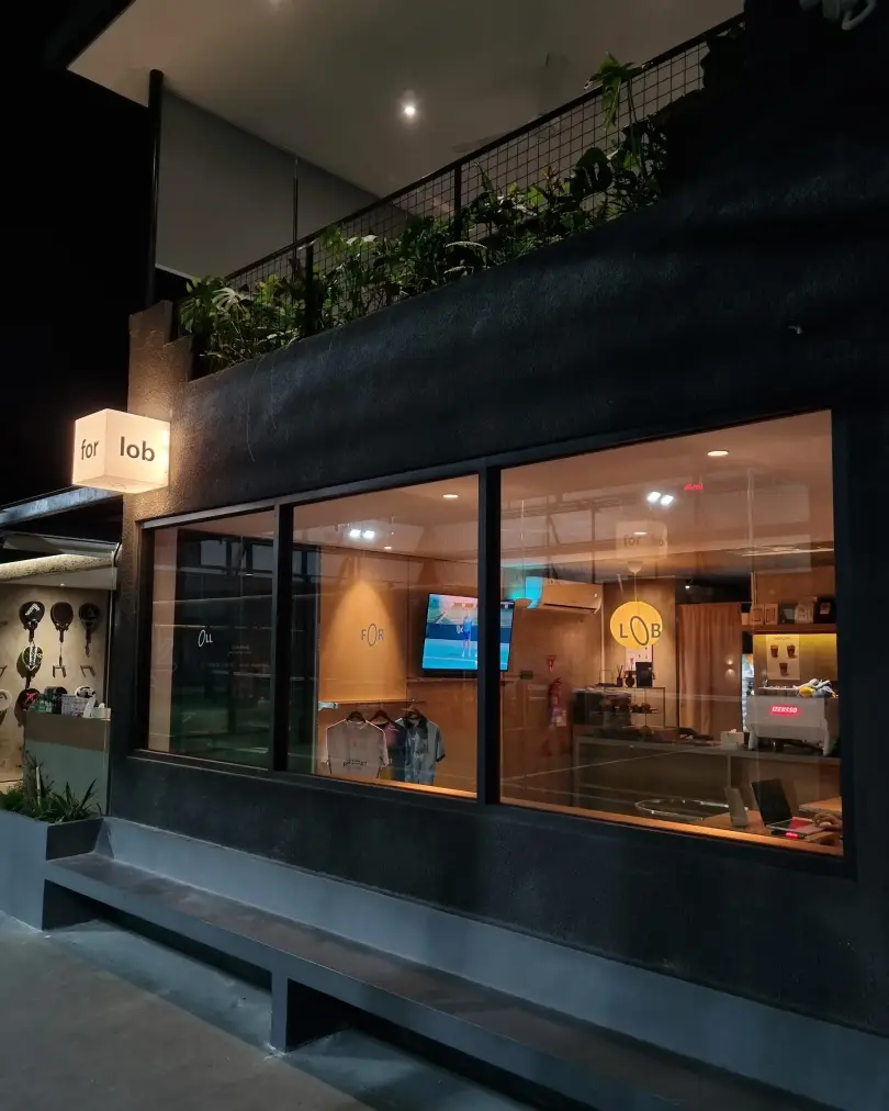 The All For Lob café glowing at night