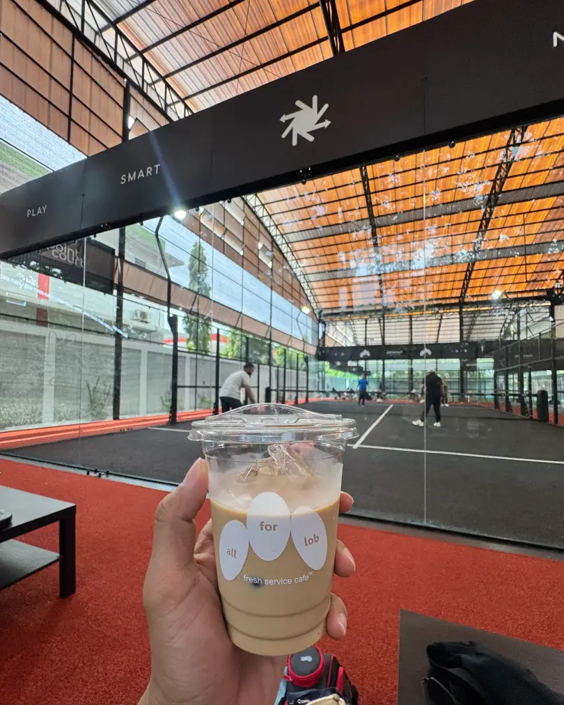 Iced coffee with the courts behind